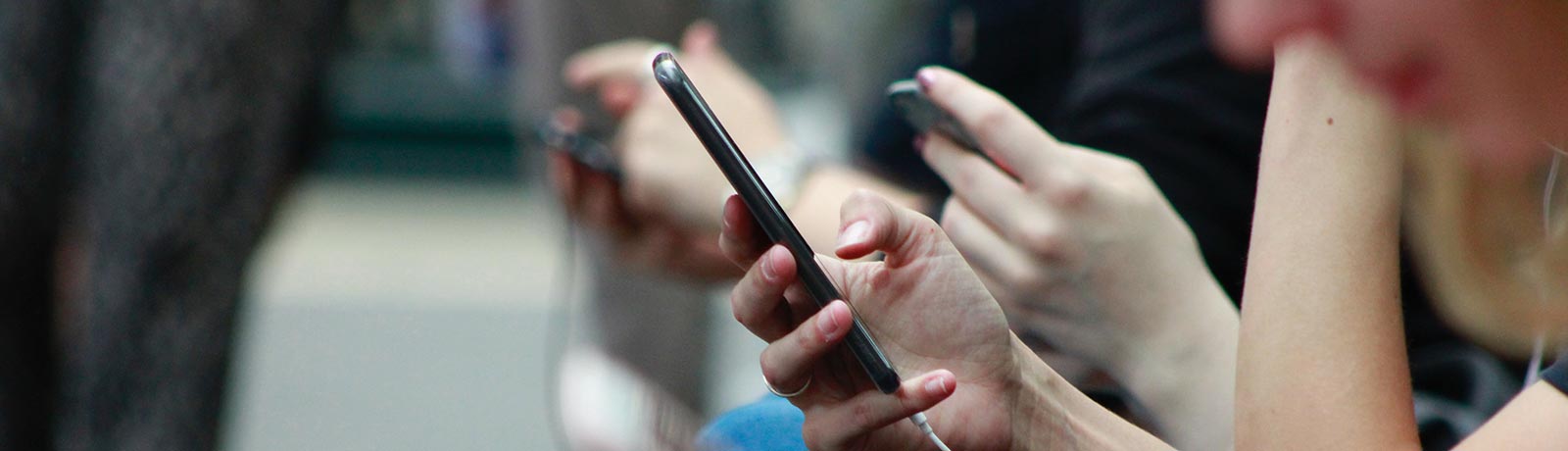 A group of people using their smartphone