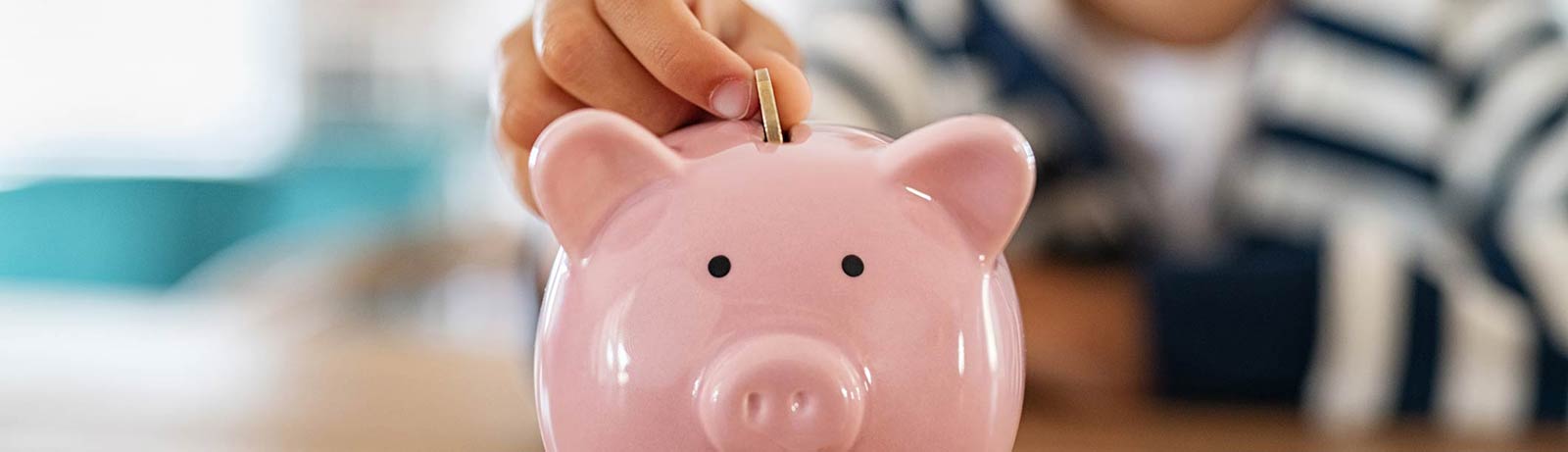 A child saving money in a piggy bank