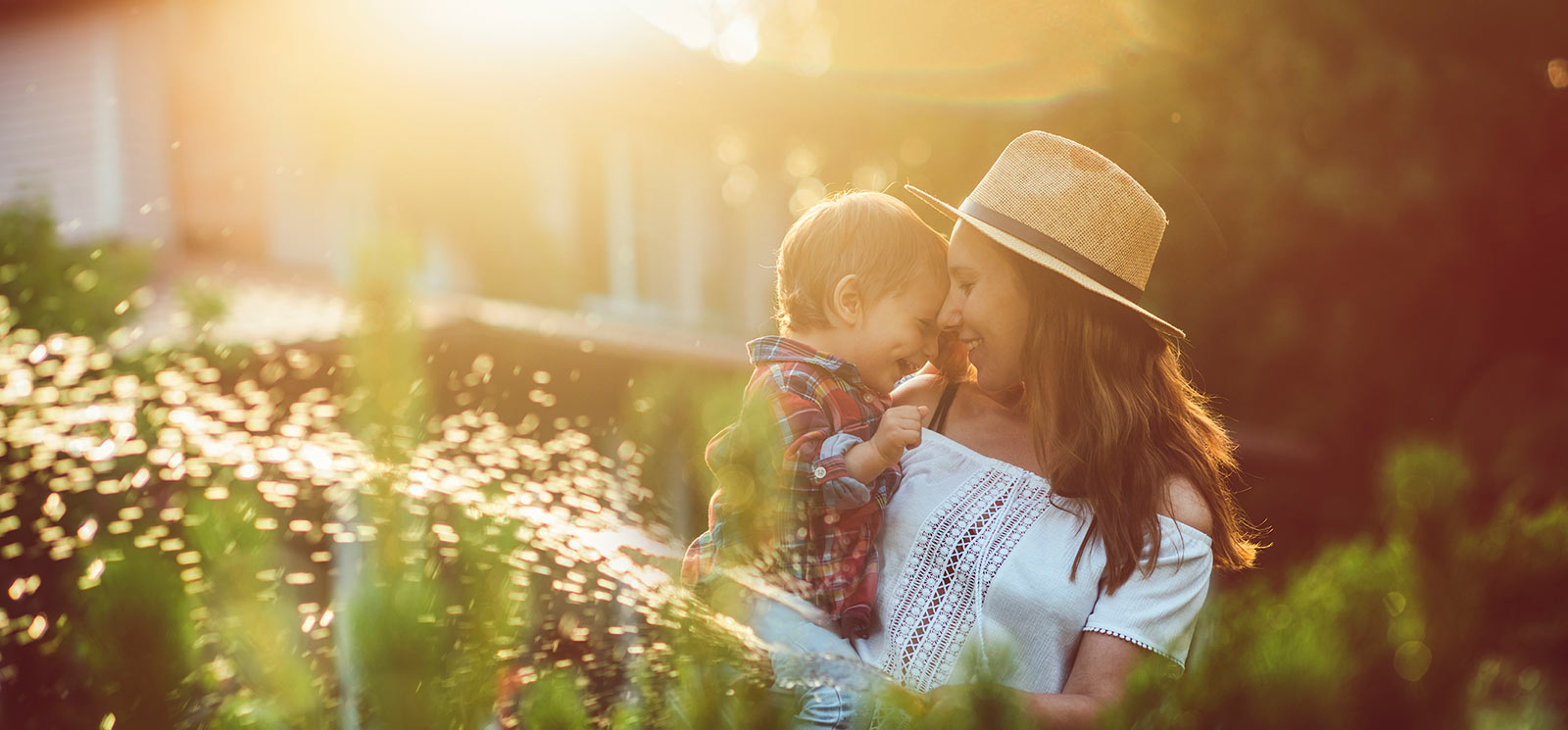 Mother and son playing outside their home