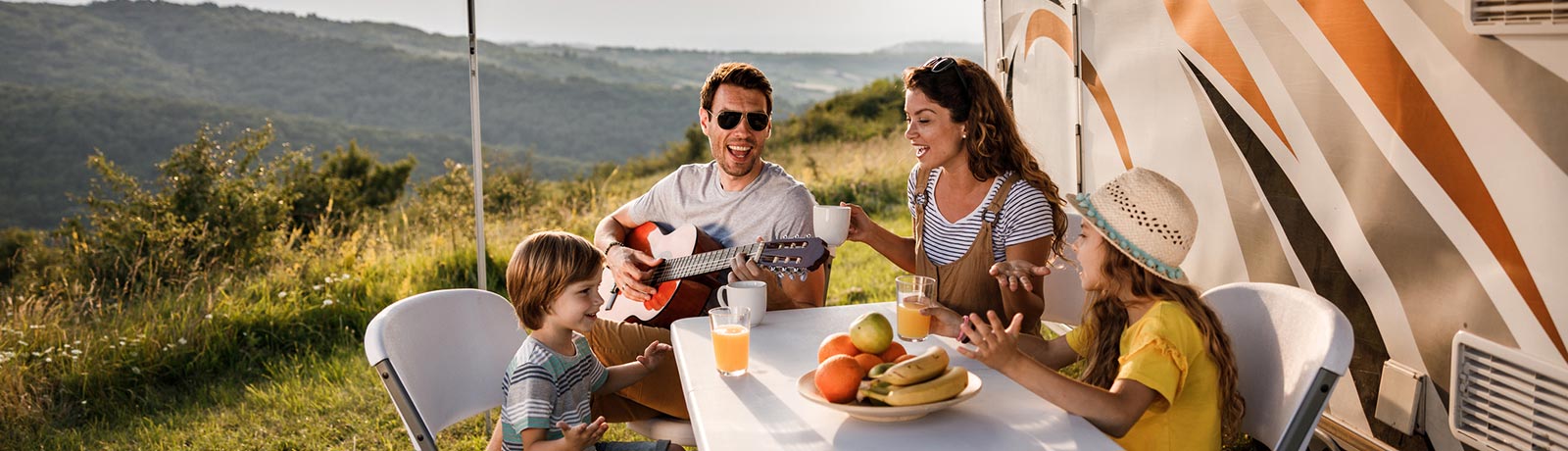 A family on vacation in the mountains in an RV